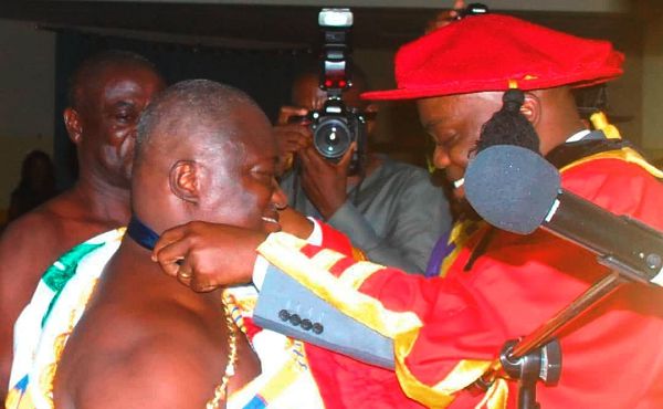 Baafuor (Dr) Ossei Hyeaman Brantuo VI being decorated by Professor Felix Nikoi Hammond