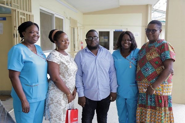 Ms Janet Quartey (right), Editor, The Mirror, with Ms Janet Donkor (2nd left), mother, and Richard Kusi Yeboah (right), son, and some health workers at Korle Bu after the presentation  