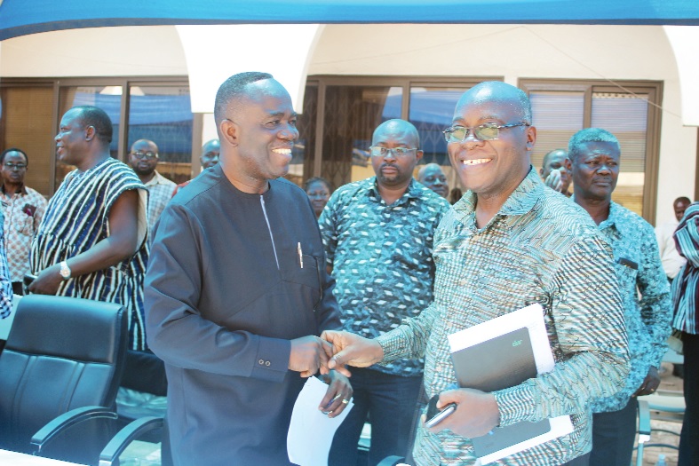 Mr Kwasi Kwaning-Bosompem (2nd left) acting Controller and Accountant General, in a handshake with Mr Joseph Brock (right), Chief Director at the office of the Head of Civil Service, at the event. 