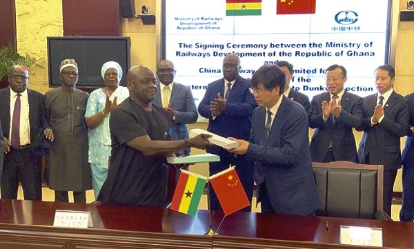 Mr Richard Diedong Dombo and Mr Xu Zhongyi exchanging the agreements