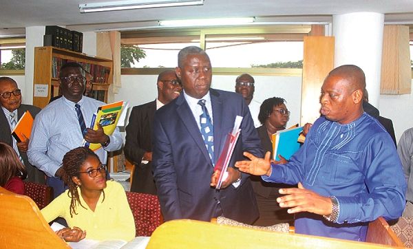 Dr Kingsley Nyarko (right) making a point when the team visited the library of the University of Ghana Law School (UGLS). Looking on is Justice Anin Yeboah (2nd right) and other members of the delegation. Picture: Maxwell Ocloo