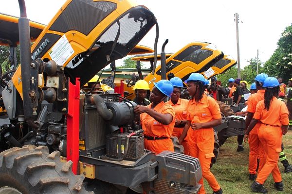  Some of the graduates displaying their skills in the servicing of tractors during the graduation ceremony