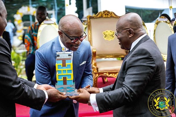  Mr Frank Adu Jr., Managing Director, Cal Bank, presents a miniature of the new Cal Bank Head office building to President Nana Addo Dankwa Akufo-Addo.