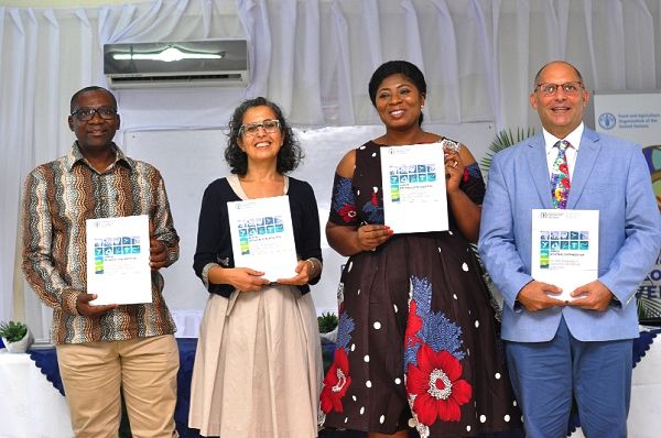 Dr Modestus Fosu (left) with Mrs Nora Berrahmouni (2nd left), Dr Lawrencia Agyepong (2nd right), and Dr Scott Newman (right) displaying copies of the report that was launched at the ceremony. Picture: NII MARTEY M. BOTCHWAY