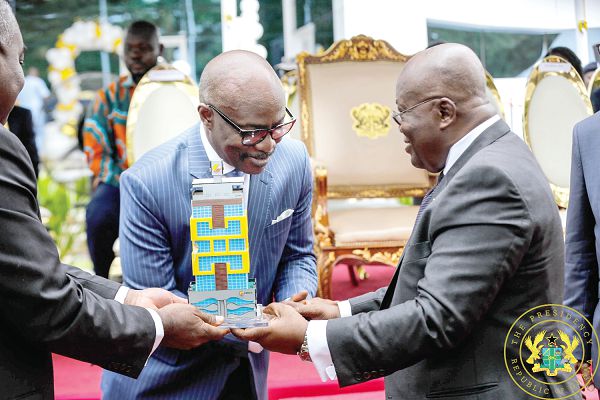 Mr Frank Adu Jr., Managing Director, Cal Bank, presents a miniature of the new Cal Bank Head office building to President Nana Addo Dankwa Akufo-Addo. INSET: The front view of the Cal Bank Head Office in Accra Picture: SAMUEL TEI ADANO