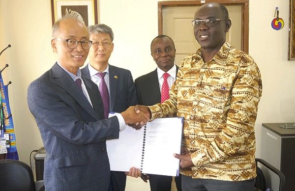 Prof. Emmanuel K. Adu (right), Director, CSIR – Animal Research Institute, exchanging documents with Mr Cho Gyoungrae, Director of the the Korean Programme on International Agriculture (KOPIA), after the signing of the Memorandum of Understanding at the CSIR Head Office. Behind them are Mr Kim Sungsoo, the Korean Ambassador to Ghana, and Prof. Victor Kwame Agyeman (2nd right), the Director General of the CSIR. Picture: PATRICK DICKSON 