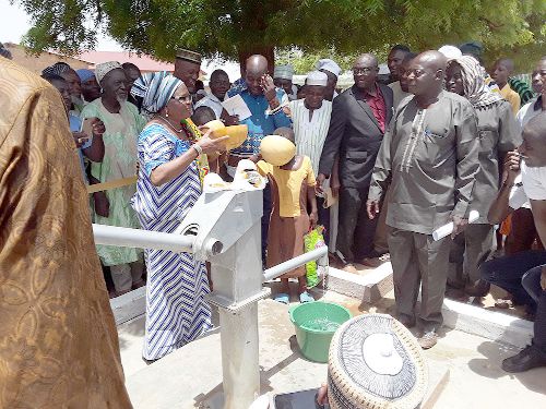  The Municipal Chief Executive of Bawku, Hania Hawa Ninchema (left) about to sample the water while Dr Dominic Edua (right), looks on  