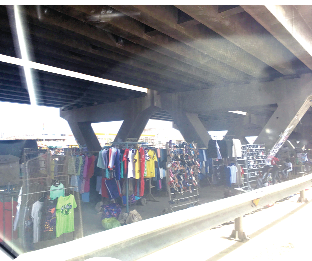 Trading activities booming under a footbridge along the Achimota-Ofankor road.