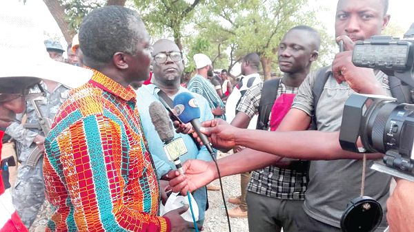  Mr Benito Owusu-Bio (left) explaining issues to journalists at Gbane during the closure of illegal mining pits in the area. With him is Mr Kwaku Antwi-Bosiako (right).