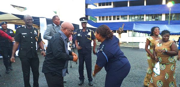 Dr Archibald Letsa (arrowed) dancing with a police officer