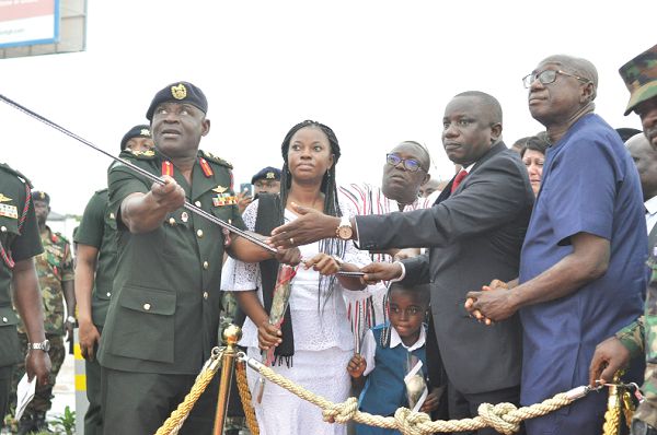Mr Dominic Nitiwul (2nd right), the Minister of Defence, being assisted by Lt Gen. Obed Boamah Akwa (left), the Chief of the Defence Staff, and Mrs Barbara Mahama (2nd left), to unveil the statue of Major Mahama. With them is Mr Ambrose Dery (right), the Minister of the Interior. Picture: NII MARTEY M. BOTCHWAY