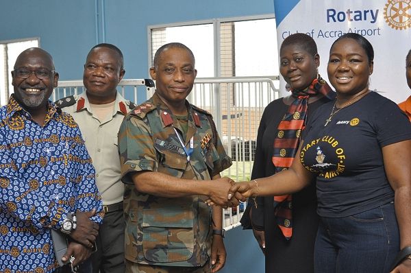 Col Nii Adjah Obodai (3rd left) in a hand shake with Ms Afua Ababio (right). 