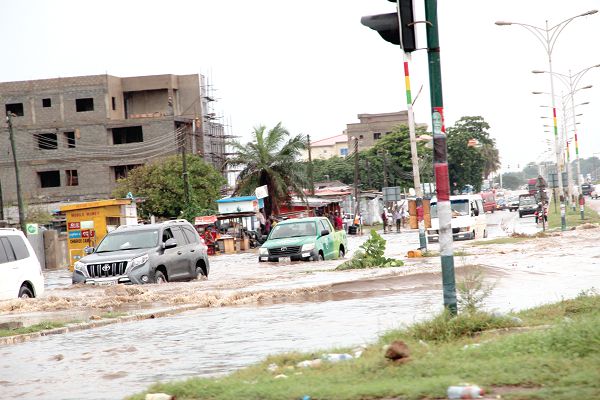 Some vehicles driving through the flood waters in Accra. Picture: ESTHER ADJEI