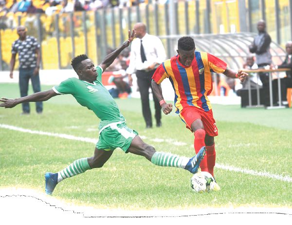 Shark’s Isaac Donkor stretches full length to stop Hearts goal getter, Manaf Umar in their enocunter yesterday.Picture: ebow hanson