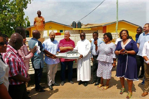 Mr Mustafa Koray Kunt (arrowed) and Mr Hikmet Akin (in red T-shirt), majority shareholder of the company, presenting the items to Very Rev. Fr Godzi (in cassock).  Picture: DELLA RUSSEL OCLOO