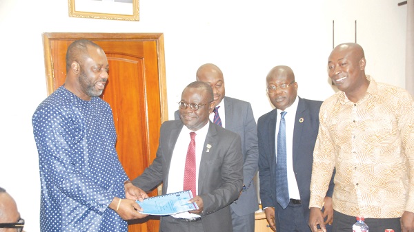   Prof Ebenezer Oduro Owusu VC of the UG (2nd left), joined by the team from the university receiving the signed document from Dr Matthew Opoku Prempeh (left)