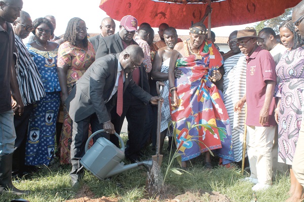  Prof. Ebenezer Oduro Owusu watering a veitchia palm plant to mark the commencement of the project. With him is Mr Joe Osei Owusu (in cap), Daasebre Emeritus Prof. Oti Boateng (4th right) and other invited guests. Picture: Maxwell Ocloo