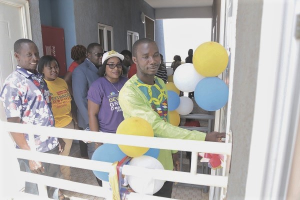 Mr Maxwell Nortey, Winner of the Devtraco/Graphic Dream Home Promotion, entering his house after presentation ceremony