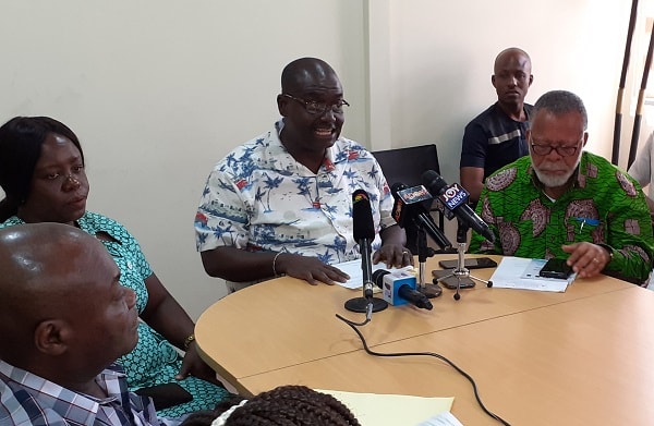 Mr Isaac Bampoe Addo addressing the press conference. To his left is Mr Peter Lumor, Chairman of TEWU, and Madam Perpetual Ofori-Ampofo (2nd left), General Secretary of Ghana Regitered Nurses and Midwifery Association (GRNMA)