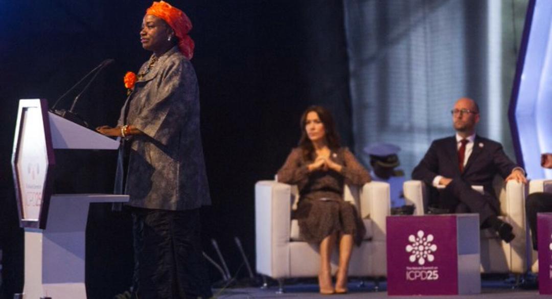 Dr. Natalia Kanem, delivering her address at the summit. With her on the podium are Crown Princess Mary ( seatedleft0 and Rasmus Prehn, (seated right) both of Denm