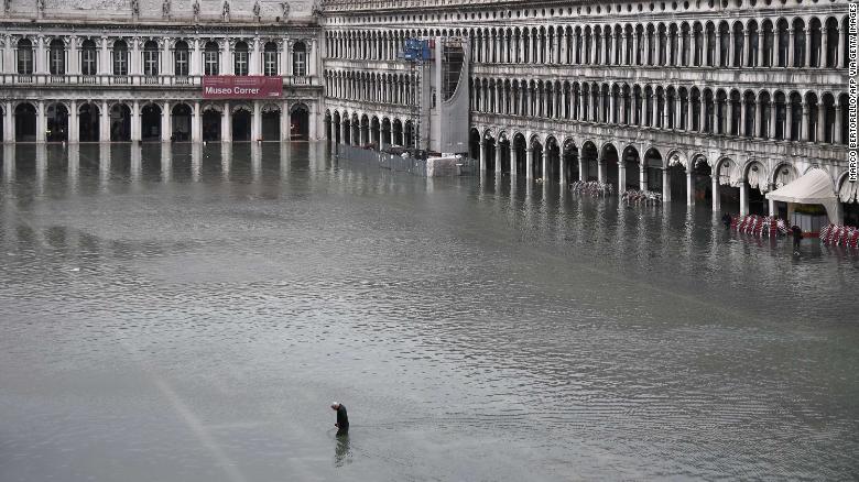 A man crosses the flooded St. Mark's Square after an exceptional overnight high tide on November 13.