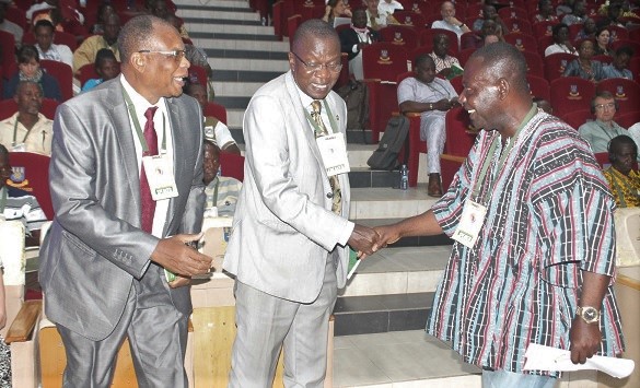 Mr Seth Osei Akoto (right), Director of Crop Services, Ministry of Food and Agriculture (MoFA), in a handshake with Mr Ernest Aubee (2nd right), Head of Agriculture Division, ECOWAS. With them is Prof. Simplice Davo Vodouhe (left) Chairman, West African Organic Network (WAfrONet).