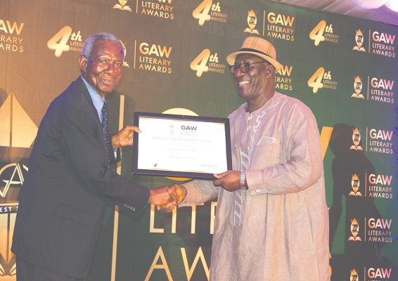  Mr Kwame Pianim (left), an Economist and Investment Consultant, presenting an award to Nii Addokwei Moffat (right) for his dedicated service to GAW.