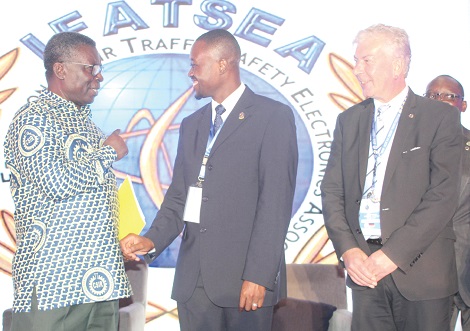  Professor Kwabena Frimpong-Boateng (left), the Minister of Environment, Science, Technology and Innovations (MESTI), interacting with Captain Kofi Atiemo, a pilot with the Emirates Airline, at the 49th General Assembly on air safety in Accra.