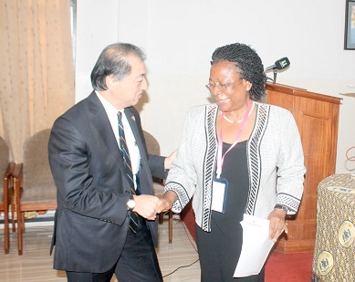 Mr Tsutomu Himenu (left), exchanging pleasantries with Prof. Uche Amazigo, Medical Parasitology and Public Health Specialist, after the symposium