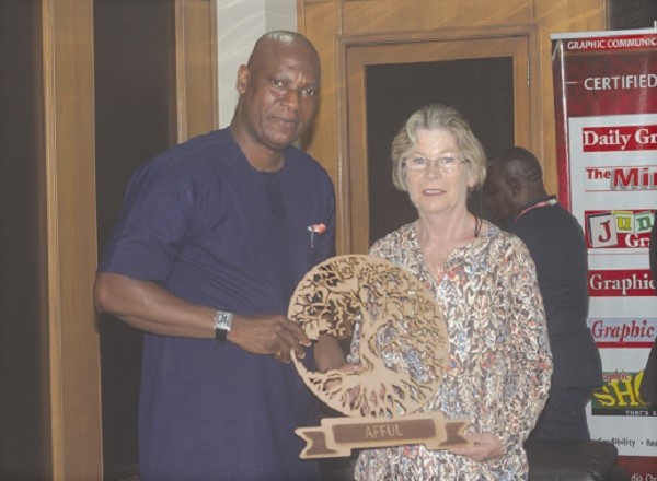 Ms Lin Larsen (right) presenting a gift to Mr Ato Affu