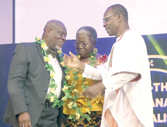 Mr Bright Blewu (left), a former General Secretary of the GJA, and Mrs Gifty Afenyi-Dadzie, a former President of the GJA, conferring with Mr Affail Monney after they had been honoured.