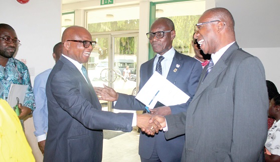 Dr Nana Ato Arthur (left), Head, Local Government Service, exchanging pleasantries with Prof Michael Tagoe (right), on his arrival at the venue for the launch of the 71st Annual New Year School and Conference. In the middle is Mr Robert Poku Kyei, Technical Advisor at the Office of the Senior Minister.