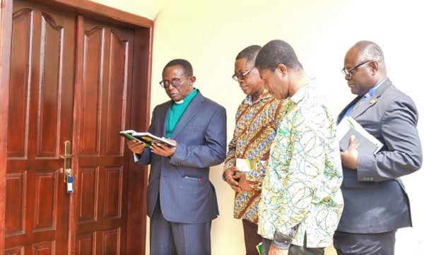 Very. Rev. Senior Emmanuel Badu Botah (left) of Ahensan Methodist Church praying during the inauguration of the bungalous. Those with  him include Mr Aaron Attua Gyau(2nd right), the Headmaster of Prempeh College, and Mr Kwabena Nyarko (2nd left), National President - Prempeh College Old Students Association.