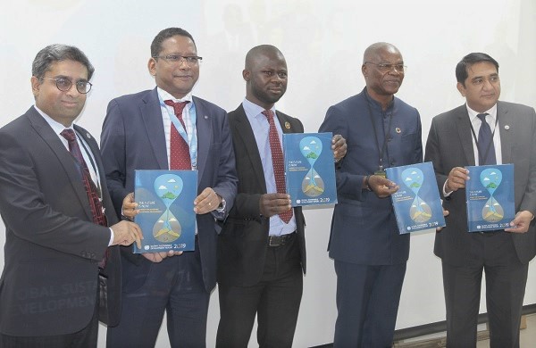 Mr Ernest G.Foli (2nd right) with Mr Abdourahamane Diallo (2nd left)  and Mr Cletus Alengah (3rd right) launching the Global Sustainable Development Report for 2019 at the UNIC Accra Resource Centre. 
