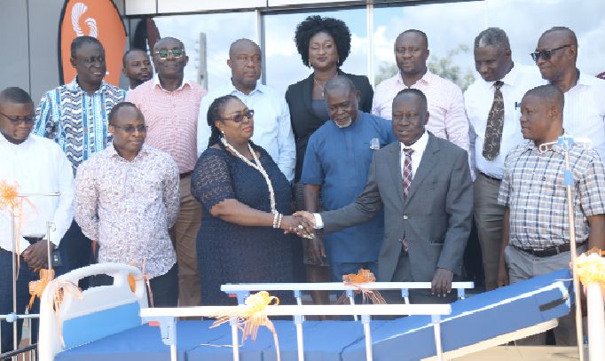  Ms Tina Mensah, Deputy Health Minister (2nd left front row), thanking Mr Kwame Osei-Prempeh, the acting MD/Group CEO of GOIL, whiles Management members of GOIL and brand Ambassador, Prof. Azumah Nelson, look on admiringly 