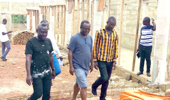  Mr Osei-Owusu (2nd right) and his entourage inspecting ongoing projects at Amoamo during the tour recently