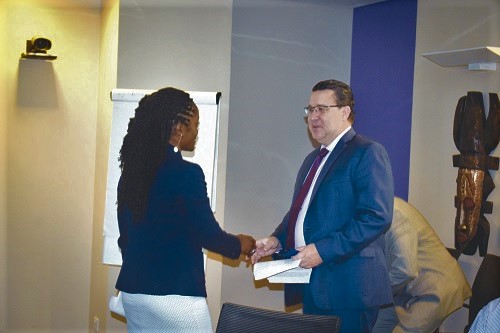 Ms Dora N. Cudjoe (left) exchanging pleasantries with Mr Pierre Laporte during the workshop on Climate Investment Fund