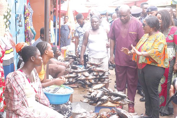 Mrs Cecilia Dapaah (right) interacting with some fishmongers at the Nungua Market. In the picture is Mr Joshua Nii Bortey (2nd right), Municipal Chief Executive, Krowor Municipal Assembly. Picture: NII MARTEY M. BOTCHWAY