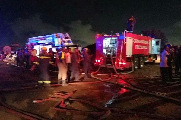 Firemen from the Ghana National Fire Service making efforts to douse the fire