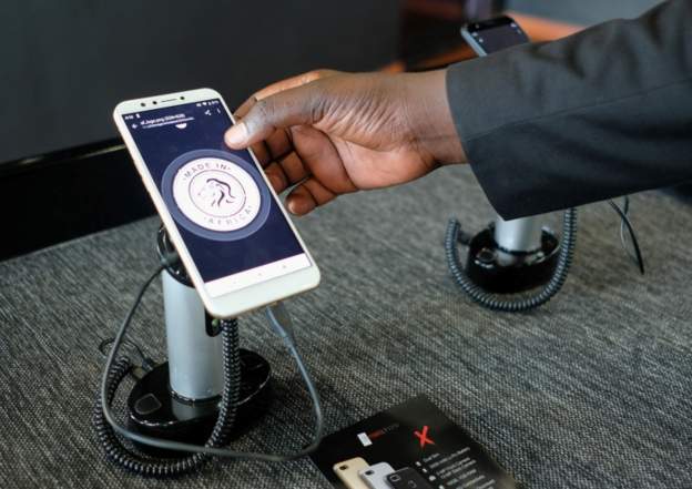  A worker operates a Mara X smartphone during the launch by Rwanda's Mara Group in Kigali