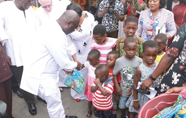 Vice-President Dr Mahamudu Bawumia sharing some gifts with children at the Princess Marie Louise Children's Hospital in Accra as part of his 56th birthday celebrations