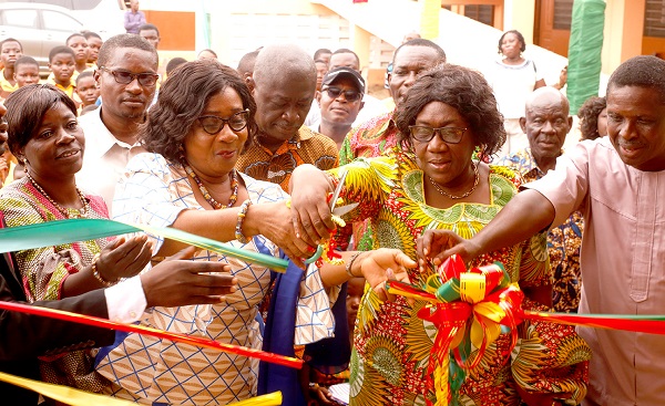 Mrs Evelyn Naa Adjeley Twum-Gyamrah (2nd left), joined by Mrs Gladys N.A. Clerk (2nd right), and Mrs Emily Akafia (left) to commission the project. INSET: The newly commissioned six unit classroom block.  Picture: NII MARTEY M. BOTCHWAY
