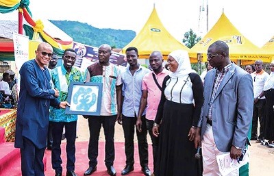 Mr Mustapha Hamid (extreme left) receiving a present from Mr Kobina Adomadzi Longdon (2nd left). with them are members of the project team