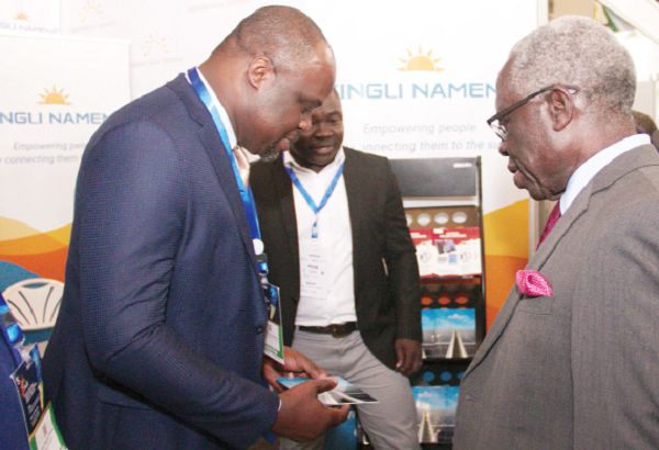 Mr Yaw Osafo-Maafo (right), the Senior Minister, interacting with Mr Firmin Nkamleu Ngassam, the MD of Yingli Namene West Africa Limited, at the 5th Ghana Renewable Energy Fair and National Energy Symposium in Accra