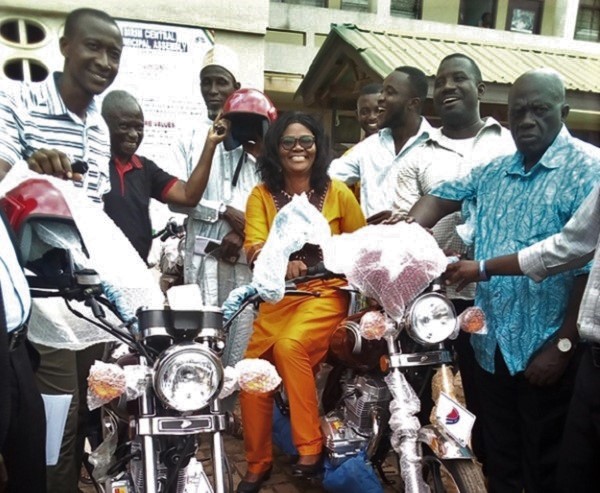  Ms Victoria Adu sitting on one of the motorbikes 