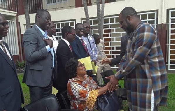 Dr Matthew Prempeh interacting with Mrs Campbell (seated) while other members look on after the swearing in ceremony