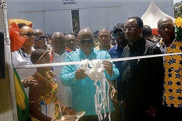 President Nana Addo Dankwa Akufo-Addo cutting the tape to inaugurate one of the two 1,000 tonnes warehouses (left) in Ejura