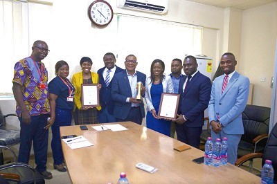The Vokacom delegation and the Daily  Graphic team led by Mr Kobby Asmah (middle) displaying the awards after their meeting
