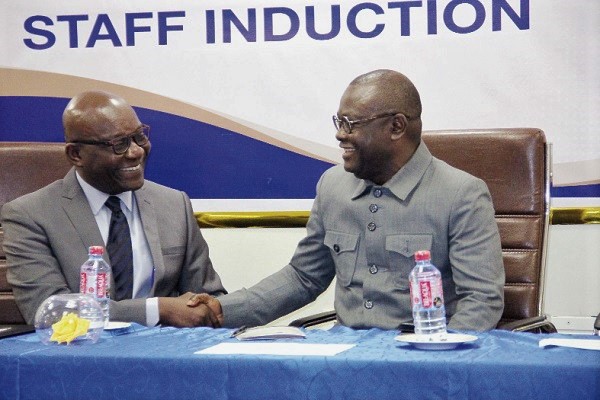  Prof. Ebenezer Oduro Owusu (right) exchanging pleasantries with Dr Darius Osei at the University of Ghana Medical Centre simulation exercise for new employees. 