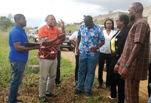 Mr Charles Tulasi (2nd left) interacting with PURC commissioners at the catchment area of Owabi Dam